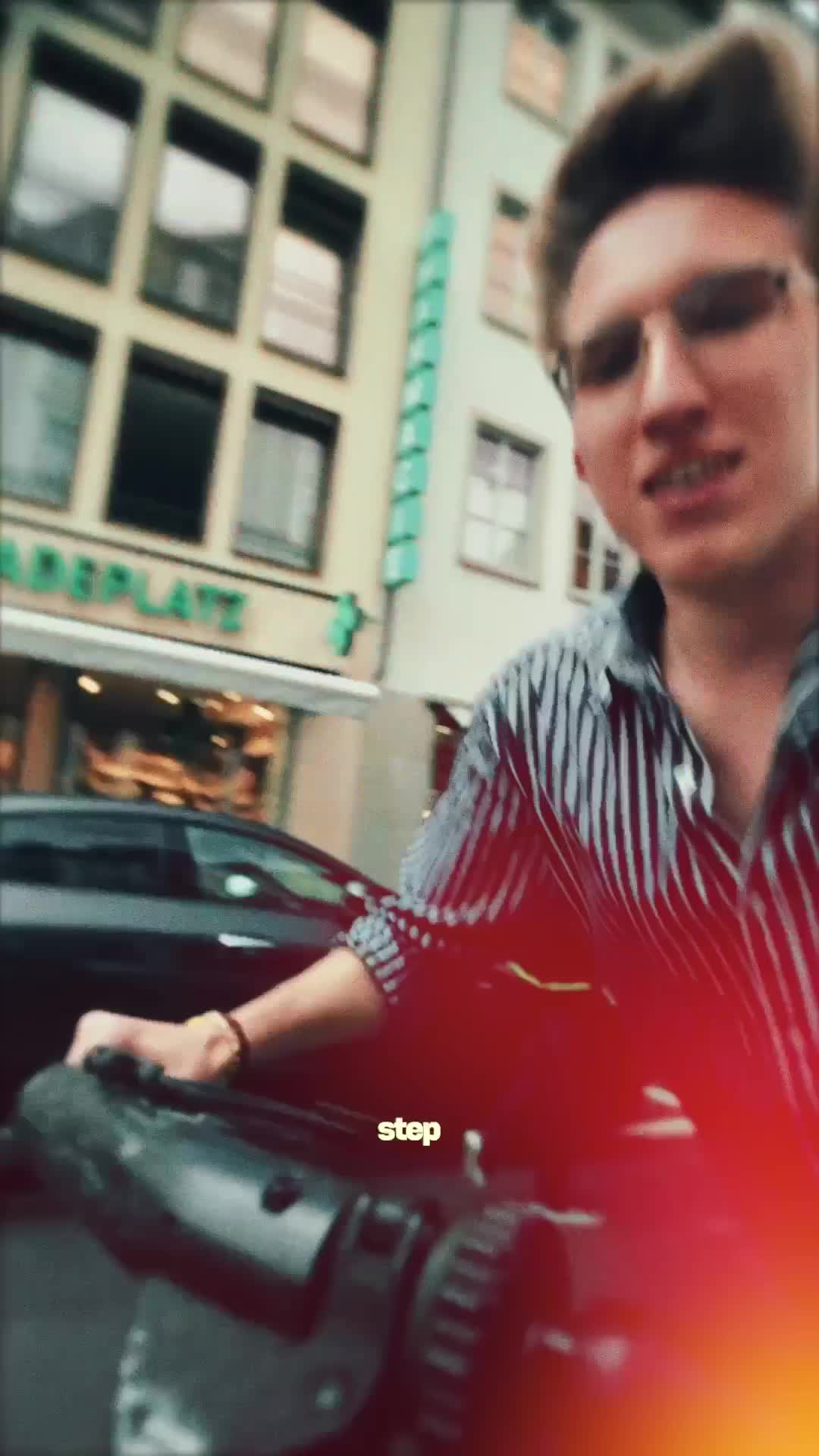 Filmmaker holding a camera on a city street with a parked car behind in a vertical reel